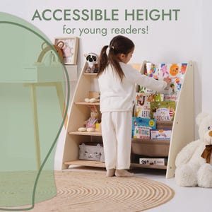 May include: A light-colored wooden bookshelf with angled sides and multiple shelves. The text "ACCESSIBLE HEIGHT for young readers!" is at the top. A young child is reaching for a book. The shelves are filled with books and toys.