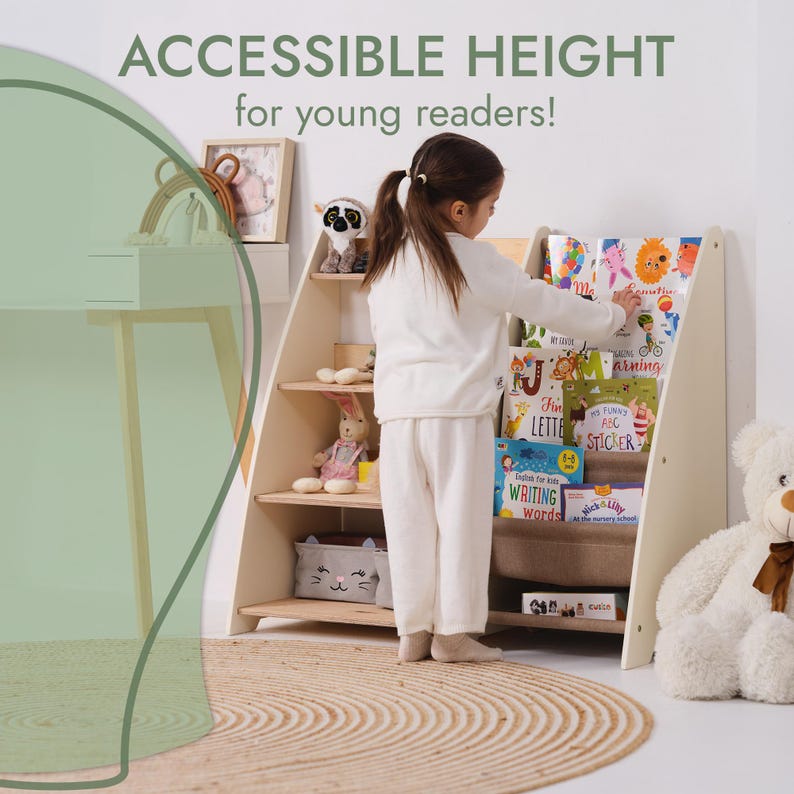 May include: A light-colored wooden bookshelf with angled sides and multiple shelves. The text "ACCESSIBLE HEIGHT for young readers!" is at the top. A young child is reaching for a book. The shelves are filled with books and toys.