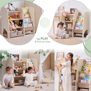 May include: A light-colored wooden bookshelf with multiple shelves, filled with books and toys. The bookshelf has a unique design with a curved side. The text "tap PLAY & find out more" is visible. The image shows children interacting with the bookshelf.