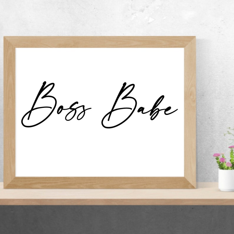 May include: A framed print with the text "Boss Babe" written in a cursive font.