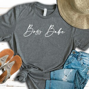May include: Gray t-shirt with the text "Boss Babe" written in white cursive script.