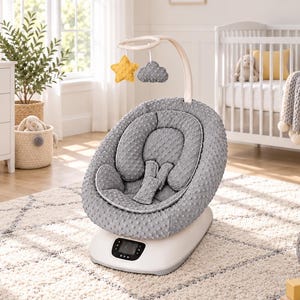 May include: A gray baby bouncer with a textured dimpled fabric seat, a removable head support insert, and a safety harness. An overhead arch features a hanging yellow star and a gray cloud. The base includes a digital control panel with buttons.