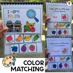 May include: An educational activity book with the title "I-SPY: FRUITS" and "COLOR MATCHING". The book features colourful illustrations of various fruits, a magnifying glass, and text prompts for colour identification. The pages are held by a black spiral binding.