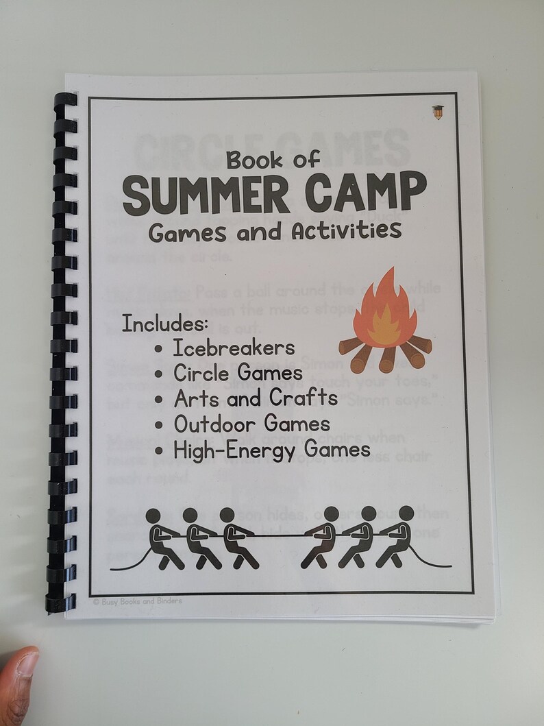 May include: A black and white book with a red and orange campfire illustration on the cover. The title is "Book of Summer Camp Games and Activities". The book includes icebreakers, circle games, arts and crafts, outdoor games, and high-energy games.