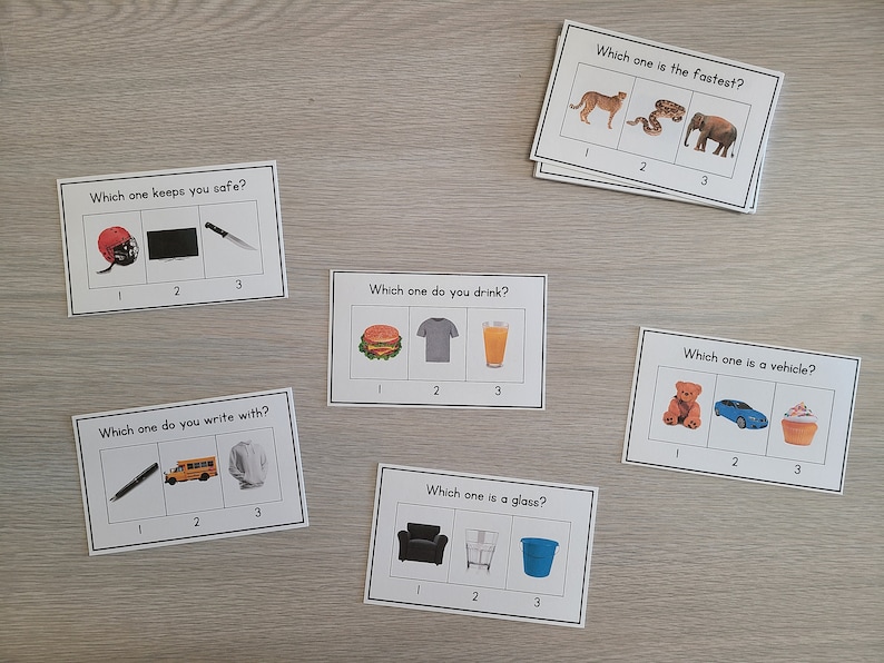 May include: Six cards with different images and questions. Each card has three images and the question "Which one..." with a different question on each card. For example, one card asks "Which one keeps you safe?" and shows a helmet, a TV, and a knife.