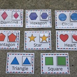 May include: Educational flashcards featuring various shapes: diamond, hexagon, circle, pentagon, star, heart, triangle, and square. Each card displays the shape and its name, with a smaller version of the shape inside a box.