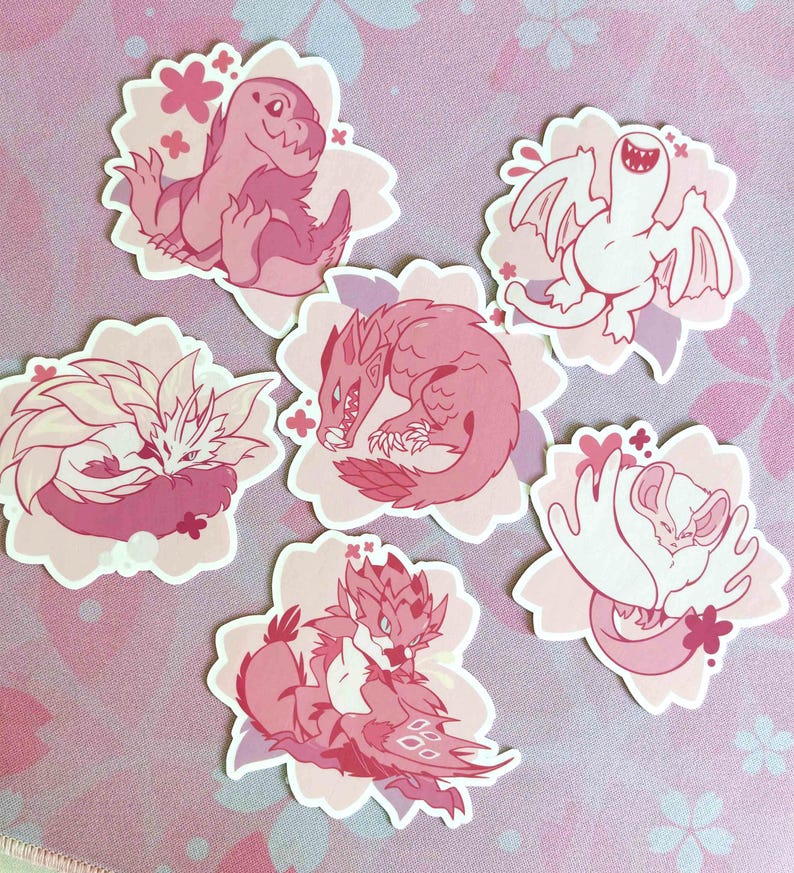 May include: A collection of six pink and white stickers featuring stylized illustrations of fantasy creatures. Each sticker is shaped like a flower with a pink background and a white border. The creatures include dragons and other mythical beings.
