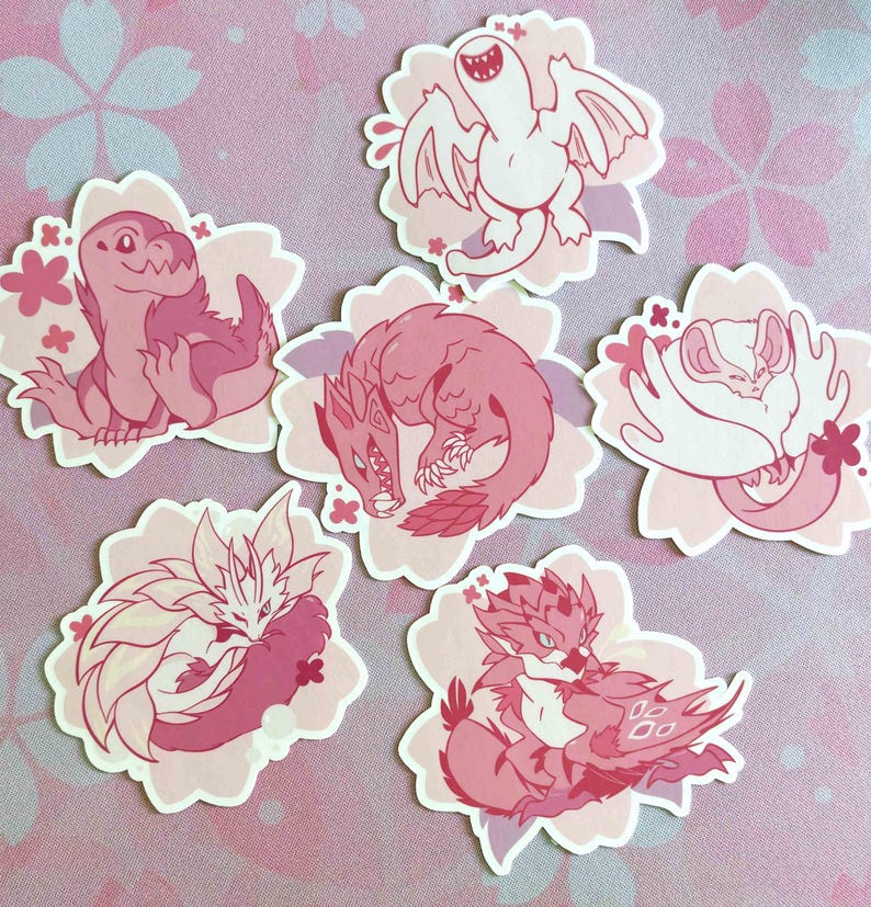 May include: A collection of six pink and white stickers featuring stylized illustrations of fantasy creatures. Each sticker is shaped like a flower and has a different creature design, including dragons and other mythical beings.