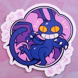 May include: A die-cut sticker featuring a cartoonish blue creature with bat-like wings, a long tail, and sharp claws. The creature has a wide grin, yellow eyes, and is set against a pink and purple background. Japanese text surrounds the image.