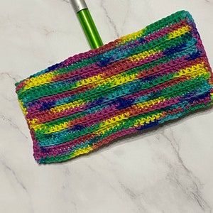May include: A colorful crocheted mop head with stripes of pink, yellow, green, blue, and purple. The mop head is attached to a silver and green mop handle.