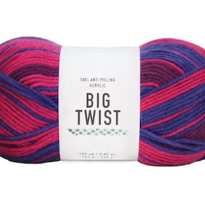 May include: A skein of Big Twist yarn in the "Spring" colorway. The yarn is a blend of pink and purple stripes. The label reads "100% Anti-Pilling Acrylic, Big Twist, Spring, 198 yd / 3.05 oz, 182 m / 110 g."