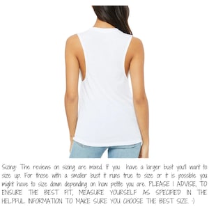 May include: A white sleeveless tank top with a scoop neck and wide armholes. The back view of the top is shown. The text on the image says, "Sizing: The reviews on sizing are mixed...PLEASE I ADVISE, TO ENSURE THE BEST FIT, MEASURE YOURSELF..."