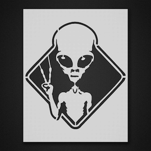 May include: Black and white stencil of an alien with large eyes and a peace sign, inside a diamond shape.