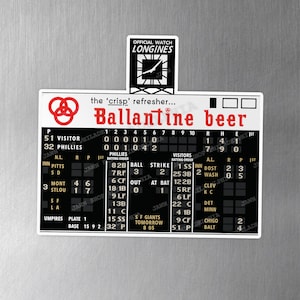 May include: A Ballantine beer magnet featuring a vintage baseball scoreboard design. The magnet includes the Ballantine logo, the text "Ballantine beer", and a baseball game score. The Longines logo is also visible.