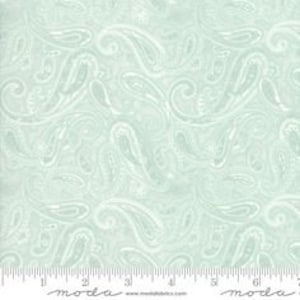 May include: A light blue fabric with a white paisley pattern. The fabric is soft and has a subtle sheen.