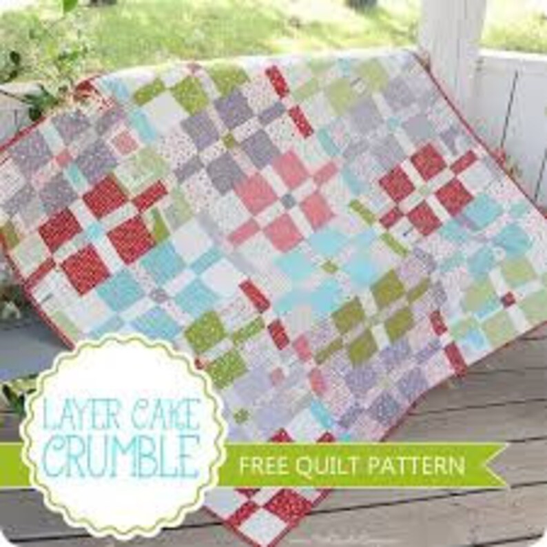 May include: A quilt pattern called "Layer Cake Crumble" with a free quilt pattern label. The quilt is made of squares of red, white, blue, green, and gray fabric.