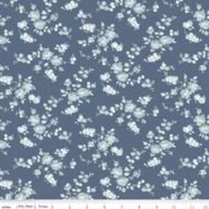 May include: A blue fabric with a white floral pattern. The flowers are small and delicate, and the pattern is repeated throughout the fabric.