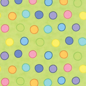 May include: A green background with a repeating pattern of colorful polka dots. The dots are in various colors, including yellow, orange, red, pink, blue, green, and purple.