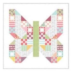 May include: A colorful butterfly quilt block with geometric patterns. The wings feature various pastel fabrics, including pink, blue, green, and yellow, with star and check designs. The body is a solid green rectangle, set against a white background.