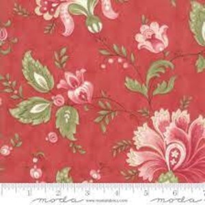 May include: Red fabric with a floral pattern featuring pink and green flowers and leaves.