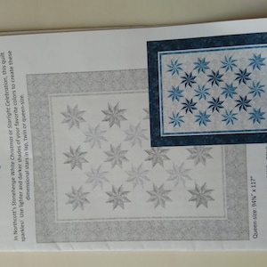 May include: A quilting pattern for a quilt called "Prism Stars" designed by Patti Carey. The pattern features a design of stars in shades of blue and white. The pattern includes instructions for making a queen-size quilt, measuring 94 inches by 117 inches, and a lap-size quilt, measuring 56 inches by 70 inches.