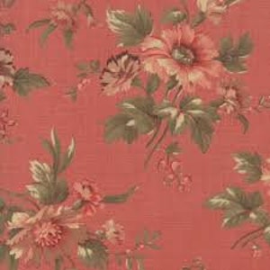 May include: Coral-colored fabric with a floral pattern. The design features large, detailed flowers in shades of peach and cream, with green and brown leaves. The fabric has a textured appearance.