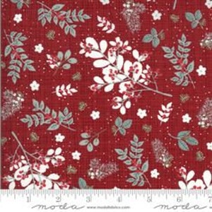 May include: Red fabric with a white and green floral pattern. The pattern includes leaves, berries, and small white flowers. The background is a textured red fabric with a subtle sparkle.