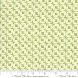 May include: A green and white geometric fabric with a repeating pattern of squares and diamonds. The fabric has a subtle sheen and a soft texture.