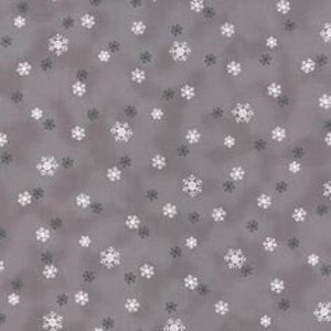 May include: A grey fabric with a white snowflake pattern. The snowflakes are scattered randomly across the fabric.