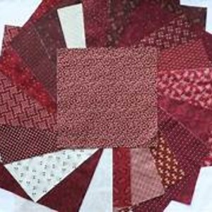 May include: A collection of 20 burgundy fabric squares with various patterns, including polka dots, geometric designs, and floral prints.