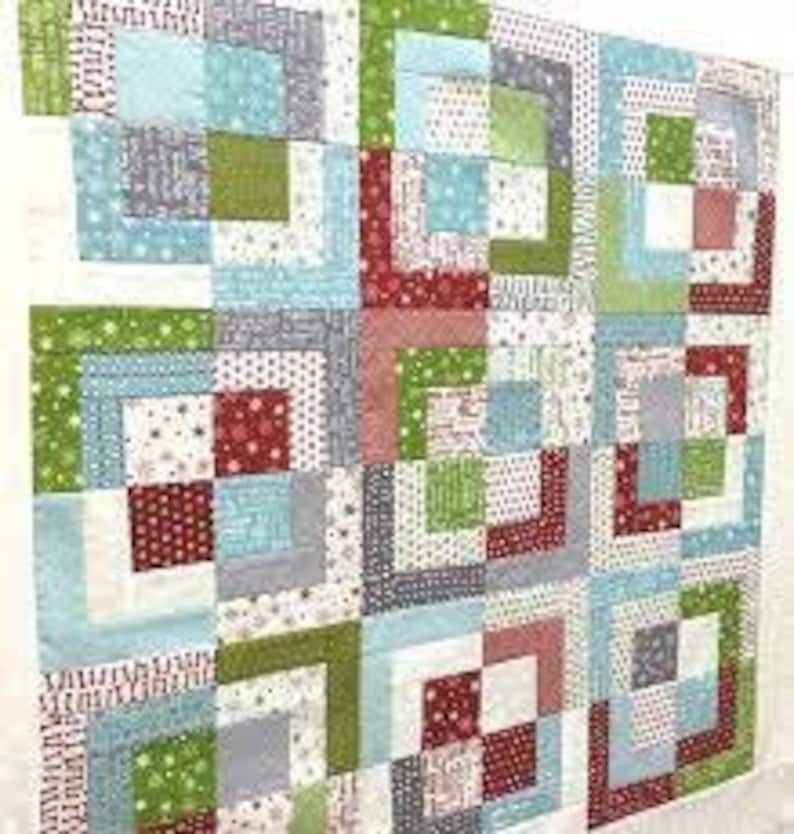 May include: A colorful quilt with a patchwork design featuring squares of red, green, blue, and white fabric.