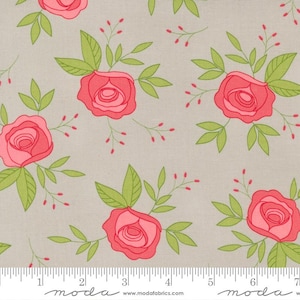 May include: Floral fabric with a repeating pattern of pink roses, green leaves, and small red berries on a light gray background. The fabric has a ruler printed along the bottom edge, with the word "moda" and website address.