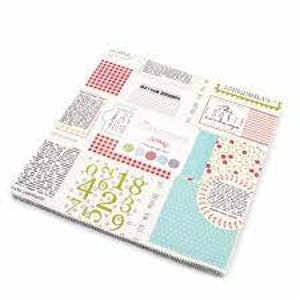 May include: A white fabric with a patchwork design featuring red and white gingham, blue and white polka dots, and a variety of text and numbers. The fabric also includes a small red and white heart pattern.