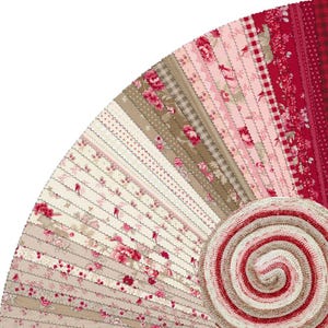 May include: A selection of fabric strips in a fan arrangement, showcasing diverse patterns and colours. The fabrics display floral, dotted, and checked designs in red, pink, cream, and brown hues. A rolled fabric bundle is positioned at the bottom right.