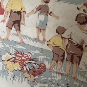 May include: A vintage fabric featuring a colorful illustration of children playing on a beach. The fabric has a light beige background with blue, yellow, red, and brown accents. The children are wearing shorts and shirts, and some are holding beach toys.