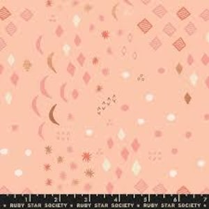 May include: Peach-colored fabric with a repeating pattern of diamonds, moons, stars, and other shapes. The design includes various shades of peach, cream, and brown. The fabric has a ruler along the bottom edge with the text "RUBY STAR SOCIETY".
