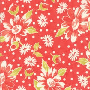 May include: Red fabric with a white floral pattern and white polka dots.