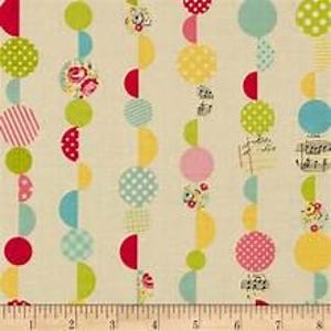 May include: A fabric with a cream background featuring vertical rows of colorful circles and half-circles. The circles are in various patterns and colors, including red, green, yellow, and blue. The fabric is measured with a ruler in inches.
