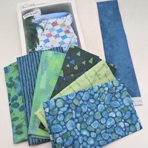 May include: A set of three ceramic mugs with a speckled, matte finish. Each mug features a different color: light blue, cream, and gray. The mugs have a simple, modern design and a comfortable handle.