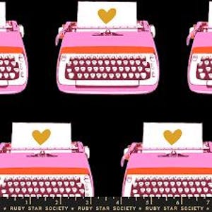 May include: A repeating pattern of pink and orange typewriters on a black background. Each typewriter has a white paper with a gold heart. The text "RUBY STAR SOCIETY" is at the bottom.