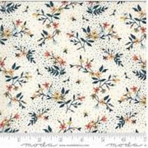 May include: White fabric with a floral pattern featuring small blue, yellow, and pink flowers with green leaves and a white background with small blue dots.