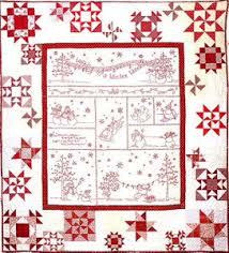 May include: A handmade quilt with a white background and red accents. The quilt features a central panel with a winter scene and the text 
