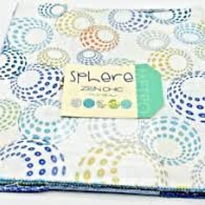 May include: A stack of fabric squares with a white background and a colorful pattern of blue, green, yellow, and orange circles. The fabric squares are labeled "SPlore Zoom Chic Collection".