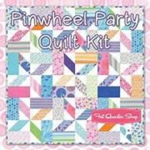 May include: A colorful quilt kit with the text "Pinwheel Party Quilt Kit." The quilt features a patchwork design with various patterns and colors, including pink, blue, green, and white. The words "Fat Quarter Shop" are also visible.