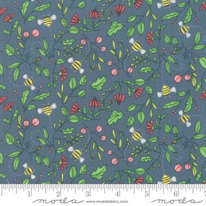 May include: A fabric with a repeating pattern of bees, flowers, and foliage in shades of green, red, and pink on a blue background. The design includes stylized bees with yellow and black stripes, red flowers, and green leaves. The fabric is marked with a ruler.