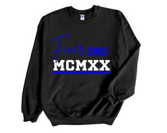 May include: Black sweatshirt with blue and white text that reads "Finer Since MCMXX".