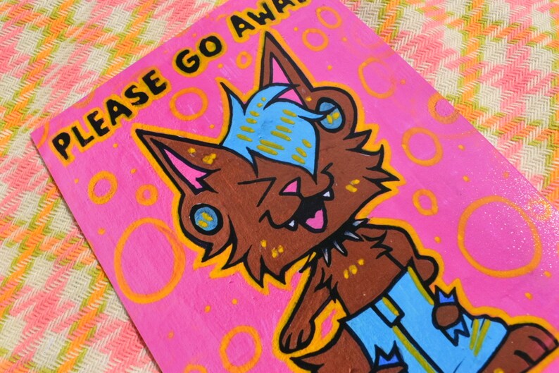 May include: A pink wooden sign with the text "PLEASE GO AWAY" in black lettering. A cartoon wolf with brown fur, blue hair, and a yellow collar is on the sign. The wolf is smiling and sticking its tongue out. The background of the sign is pink with orange circles.