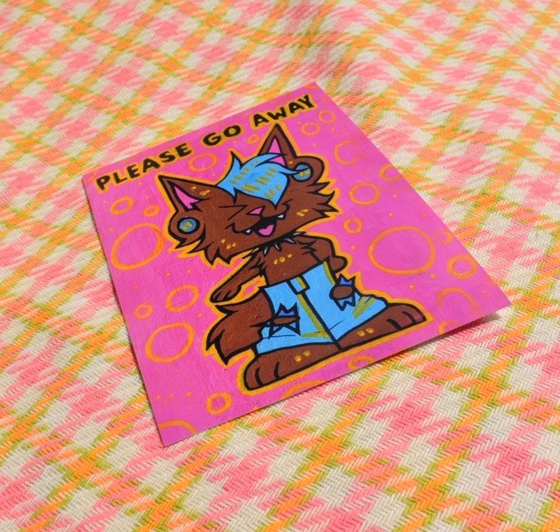 May include: A pink background with a cartoon wolf wearing blue jeans and a yellow shirt. The wolf has blue hair and is saying "PLEASE GO AWAY".