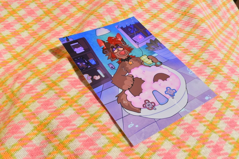 May include: A colorful illustration depicts a cartoon character in a bathtub, holding a waffle. The character has brown fur, red hair, and is wearing headphones. The background shows a room with shelves and a window.
