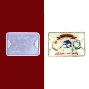 May include: A white plastic tray with a clear plastic lid. The tray has a design of a milk carton, cookies, and carrots with the text "Dear Santa with love - our family".